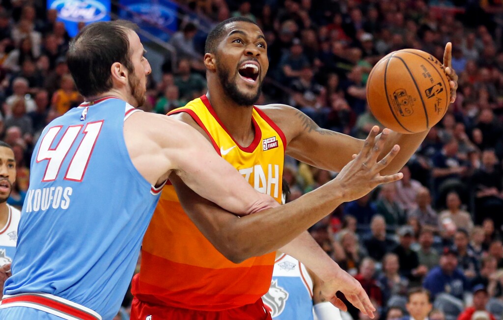 Sacramento Kings center Kosta Koufos (41) fouls Utah Jazz forward Derrick Favors in the first half during an NBA basketball game Saturday, March 17, 2018, in Salt Lake City. (AP Photo/Rick Bowmer)