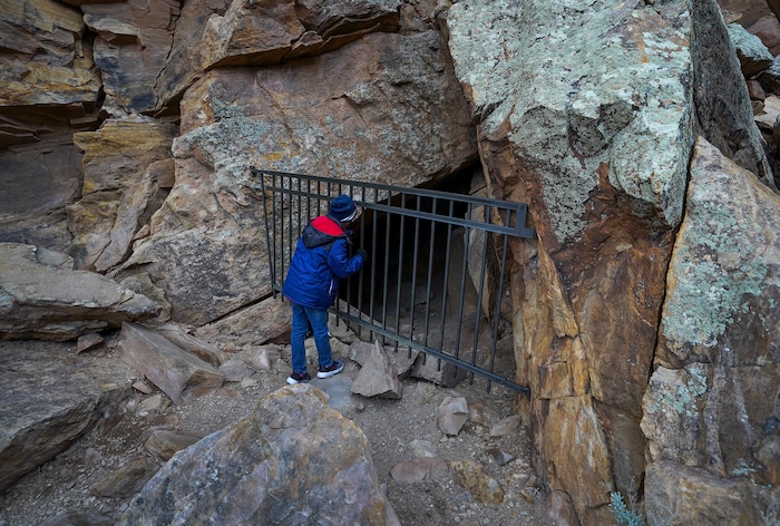 (Leah Hogsten | The Salt Lake Tribune) Donovan Brown, 10, peeks into the Parowan Gap cave where artifacts were discovered and dated during the spring equinox observance, Saturday, Mar. 20, 2021 while on an interpretive tour with a program guide from the Parowan Heritage Foundation.