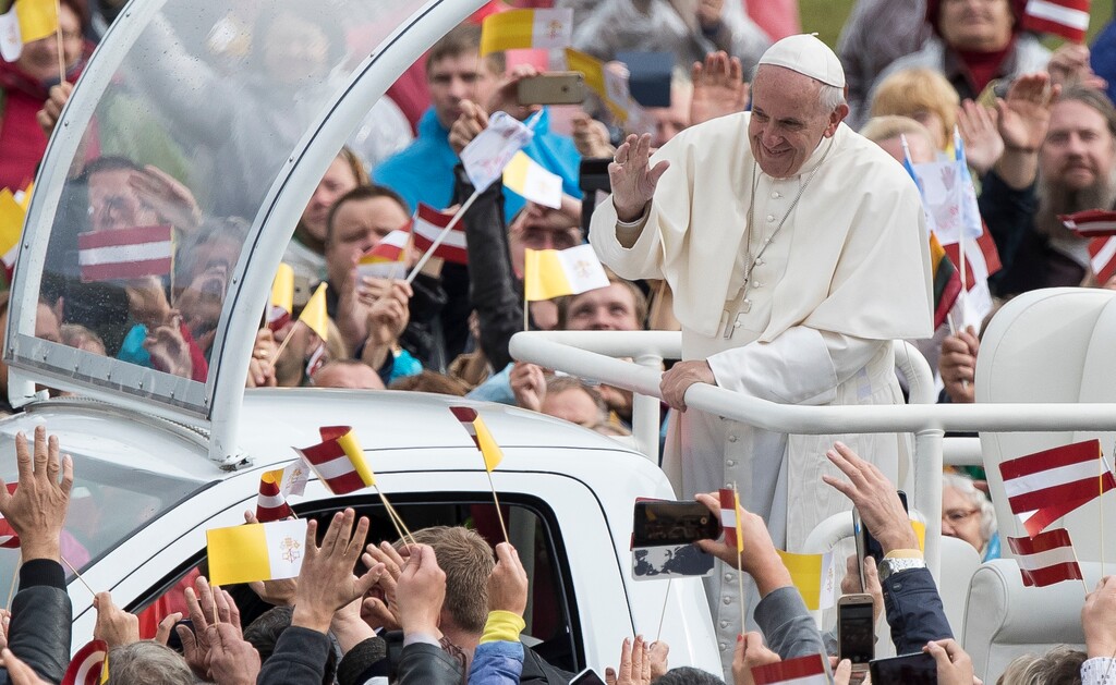 (AP Photo/Mindaugas Kulbis) Pope Francis greets people as he arrives for a Holy Mass at the Shrine of the Mother of God, in Aglona, Latvia, Monday, Sept. 24, 2018. Francis is visiting Lithuania, Latvia and Estonia to mark their 100th anniversaries of independence and to encourage the faith in the Baltics, which saw five decades of Soviet-imposed religious repression and state-sponsored atheism.