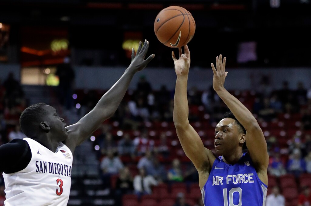 Air Force's A.J. Walker (10) shoots as San Diego State's Aguek Arop (3) defends during the first half of a Mountain West Conference tournament NCAA college basketball game Thursday, March 5, 2020, in Las Vegas. (AP Photo/Isaac Brekken)