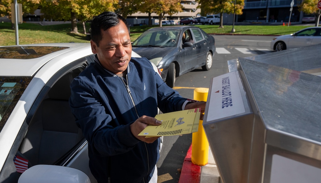 (Rick Egan | The Salt Lake Tribune)  A man drops his ballot in the drop box at the Salt Lake County Government Center on Wednesday, Oct. 30, 2024.
