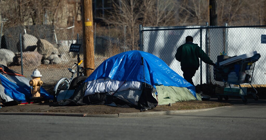 (Francisco Kjolseth  | The Salt Lake Tribune) Homeless camp out in downtown Salt Lake City on Thursday, Dec. 3, 2020. A Salt Lake Tribune analysis of dollars spent on Operation Rio Grande from Salt Lake City, Salt Lake County and the state has found that the vast majority of new spending went to fund law enforcement, jail beds, court and policing, while less money went to services, housing and shelter.