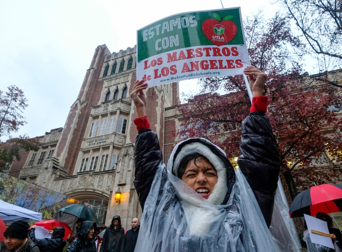 (Ringo H.W. Chiu | The Associated Press)  Alessandro Niculescu, 10, holds up a sign in the rain during a teacher strike outside John Marshall High School, Monday, Jan. 14, 2019, in Los Angeles. Tens of thousands of Los Angeles teachers are striking after contentious contract negotiations failed in the nation's second-largest school district.