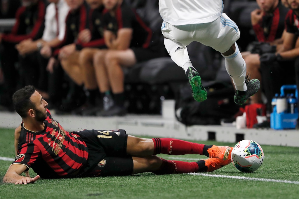 Atlanta United forward Justin Meram (14) slides to knock the ball away from a Minnesota United player during the first half of the U.S. Open Cup soccer match Tuesday, Aug. 27, 2019, in Atlanta. (AP Photo/John Bazemore)