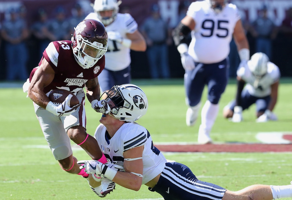 Mississippi State wide receiver Keith Mixon (23) knocks the helmet off BYU defensive back Zayne Anderson (23) during the first half of their game Saturday. (AP Photo/Jim Lytle)