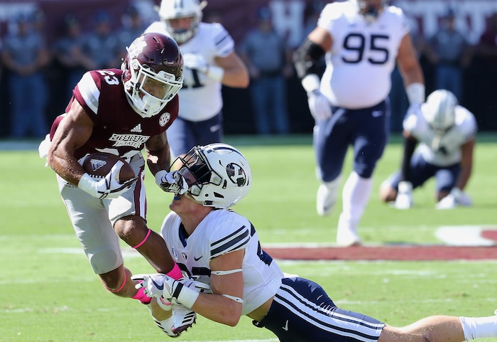 Mississippi State wide receiver Keith Mixon (23) knocks the helmet off BYU defensive back Zayne Anderson (23) during the first half of an NCAA college football game in Starkville, Miss., Saturday, Oct. 14, 2017. (AP Photo/Jim Lytle)