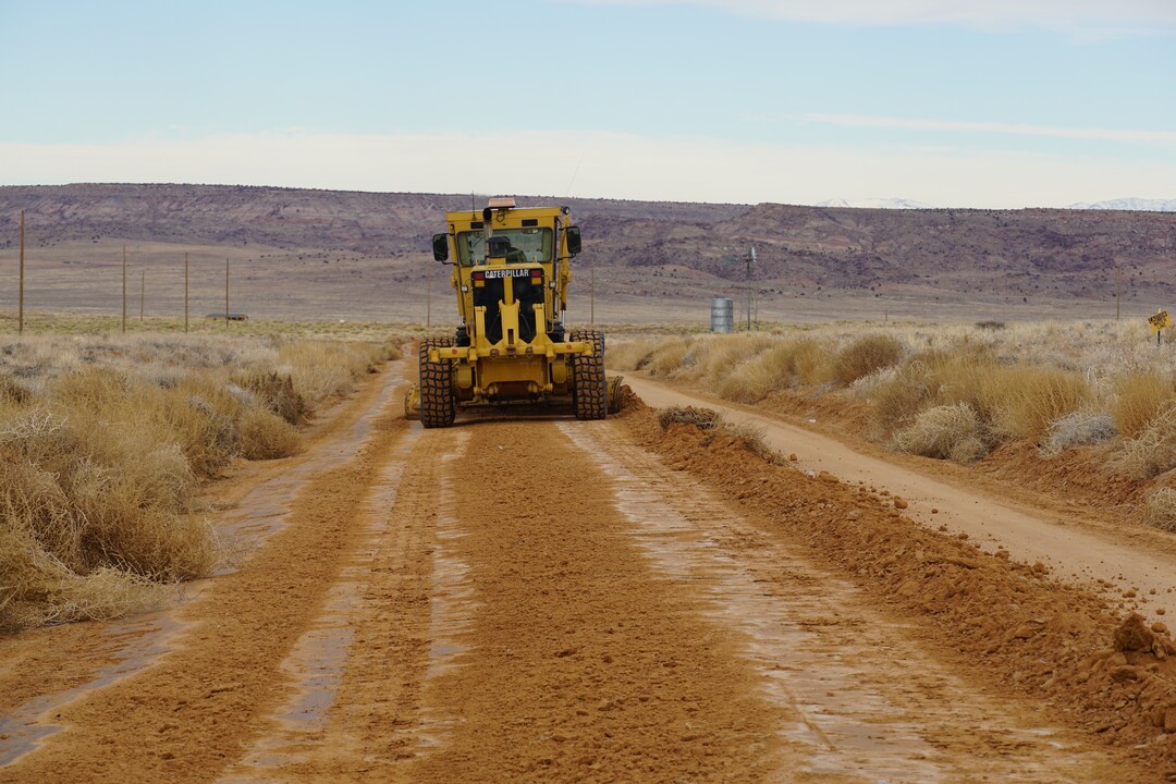 (Zak Podmore | The Salt Lake Tribune) A grader from the Navajo Department of Transportation smooths a road near the Red Mesa Chapter House in southern San Juan County.