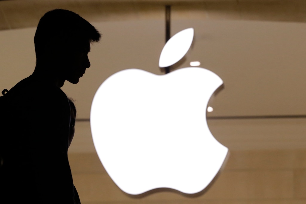 File-This May 31, 2018, file photo shows a customer entering the Apple store in New York. Flush with savings from lower tax bills and profits from a growing economy, big U.S. companies are spending a record amount buying back their own stock. Apple, Cisco Systems and other technology giants helped lead the way. Apple has traditionally been one of the biggest repurchasers of its own stock, and it set a record in the first quarter by spending roughly $23 billion. (AP Photo/Mark Lennihan)