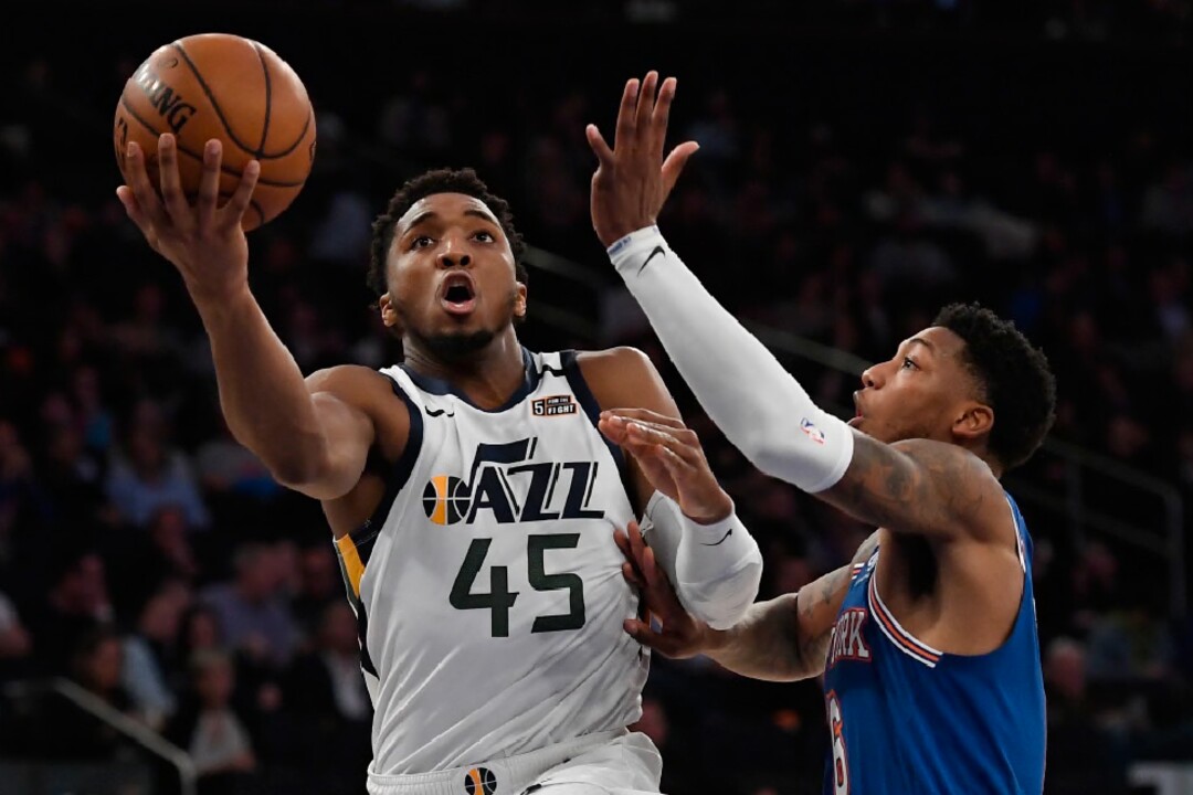 Utah Jazz guard Donovan Mitchell (45) shoots next to New York Knicks guard Elfrid Payton during the second half of an NBA basketball game in New York, Wednesday, March 4, 2020. (AP Photo/Sarah Stier)