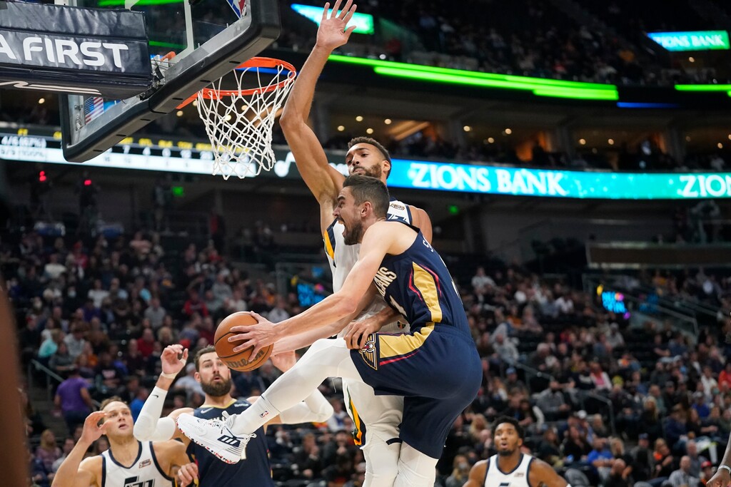 New Orleans Pelicans guard Tomas Satoransky, foreground, goes to the basket as Utah Jazz center Rudy Gobert, top, defends in the first half of a preseason NBA basketball game Monday, Oct. 11, 2021, in Salt Lake City. (AP Photo/Rick Bowmer)