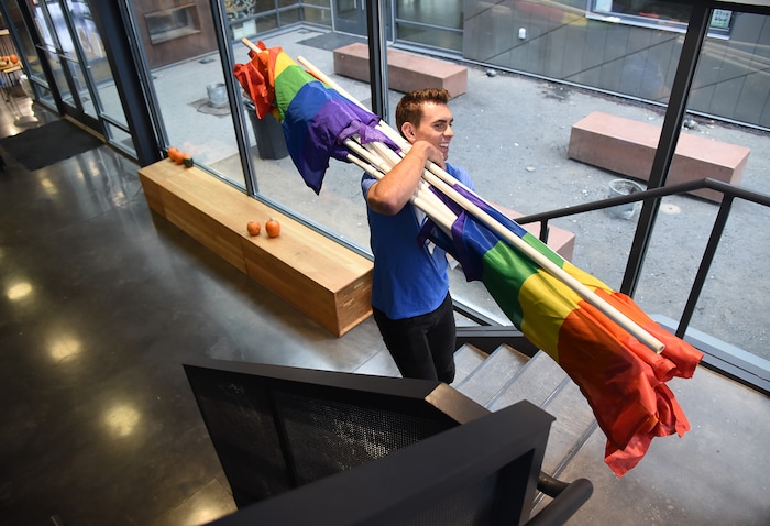(Francisco Kjolseth | The Salt Lake Tribune) Ballet West dancer Lucas Horns gathers gay pride flags as part of a service project to convert them over to transgender pride flags for the upcoming Transgender Day of Remembrance on Nov. 20. Horns who volunteers at the VOA Youth Resource Center, where he leads an LGBTQ support group, involves homeless youth through discussion and service projects. With their help Horns goal was to transfer 500 flags that would be placed from Ogden to Provo.