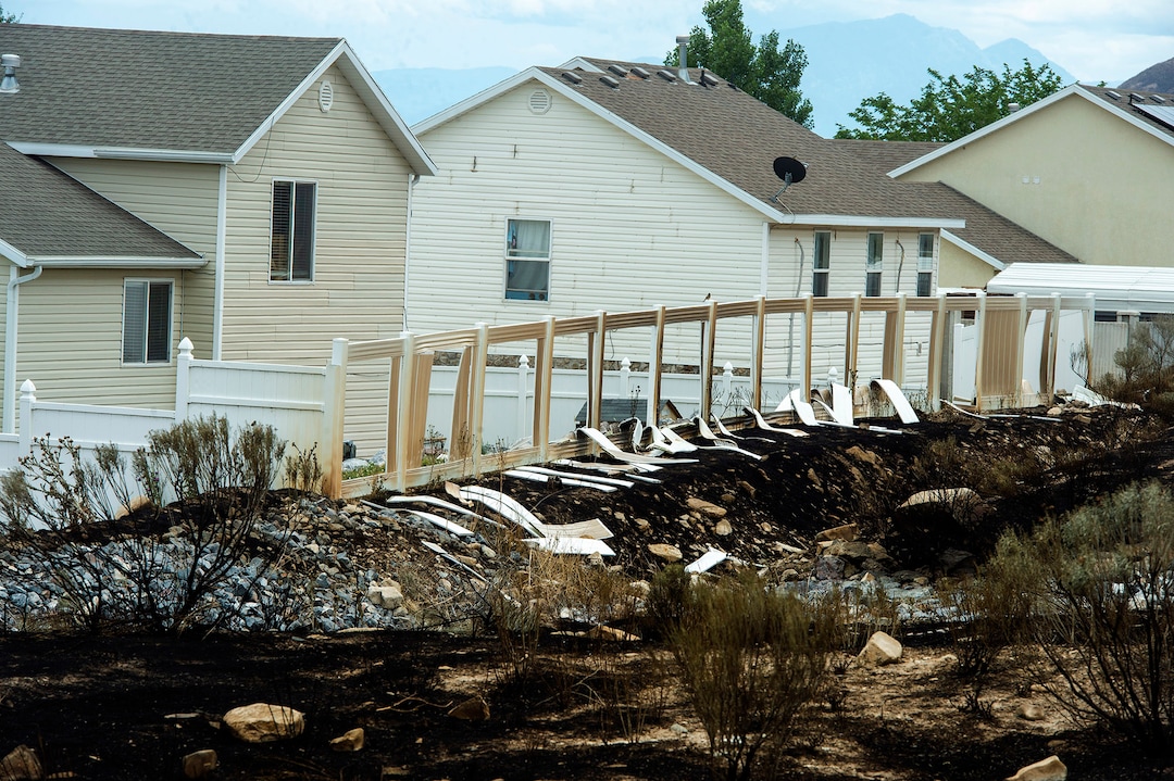 (Rick Egan  |  The Salt Lake Tribune)      The Knolls fire melted fences and did some property damage, but spared the homes on Sunrise Drive in Sunday's fire, in Saratoga Springs, Monday, June 29, 2020.