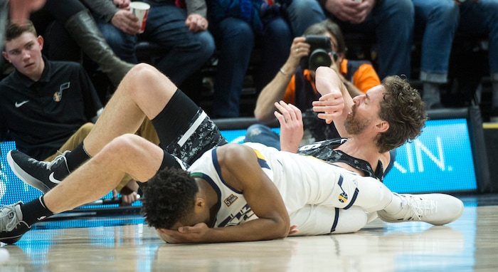 (Rick Egan  |  The Salt Lake Tribune)   San Antonio Spurs center Pau Gasol (16) hits the ground along with Utah Jazz guard Donovan Mitchell (45), after colliding on the play, in NBA action, in Salt Lake City, Monday, February 12, 2018.