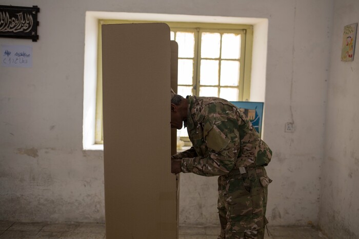 A security guard votes for Kurdish independence at polling station in the disputed city of Kirkuk, Monday Sept. 25, 2017. Iraq's Kurdish region vote in a referendum on whether to secede from Iraq. The vote has cause tensions in Kirkuk which is divided between Kurds, Turkmen and Arabs. (AP Photo/Bram Janssen)