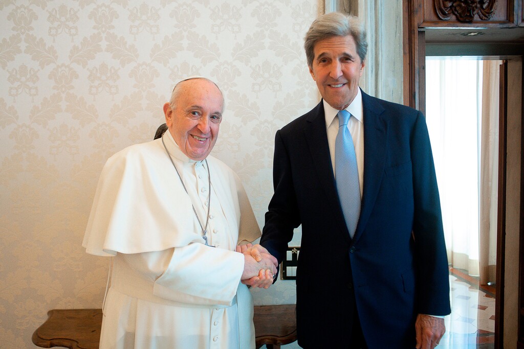 (Vatican Media via AP) Pope Francis and John Kerry, right, shake hands as they pose for a photo at the Vatican, Saturday, May 15, 2021. Former U.S. Secretary of State John Kerry, currently President Biden’s envoy on the climate, met in private audience with Pope Francis on Saturday, afterward calling the pope “a compelling moral authority on the subject of the climate crisis” who has been “ahead of the curve.” Kerry told Vatican News in an interview that the pope speaks with “unique authority, compelling moral authority, that hopefull can push people to greater ambition to get the job done.