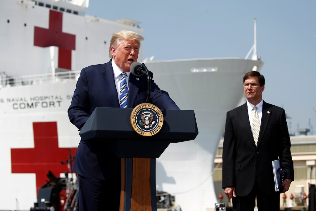 (Patrick Semansky | AP) President Donald Trump speaks in front of the U.S. Navy hospital ship USNS Comfort at Naval Station Norfolk in Norfolk, Va., Saturday, March 28, 2020. The ship is departing for New York to assist hospitals responding to the coronavirus outbreak. Defense Secretary Mark Esper is at right.