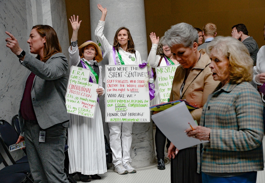 (Francisco Kjolseth | The Salt Lake Tribune) Kelly Jones, Charlotte Maloney and Jody England Hansen, from left, wave back to young student women visiting the Capitol as they dress up as Silent Sentinels (women who protested outside the White House a century ago for suffrage), as they attend the legislative session on Tuesday, Feb. 4, 2020, to encourage Utah legislators to ratify the Equal Rights Amendment. At right is conservative political activist Gayle Ruzicka, president of the Utah Eagle Forum, an opponent to ratifying the ERA.