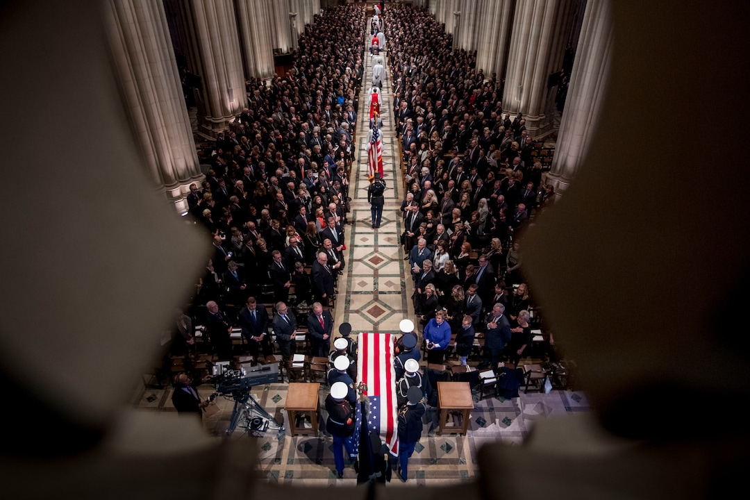 The flag-draped casket of former President George H.W. Bush is carried by a military honor guard during a State Funeral at the National Cathedral, Wednesday, Dec. 5, 2018, in Washington. (AP Photo/Andrew Harnik, Pool)