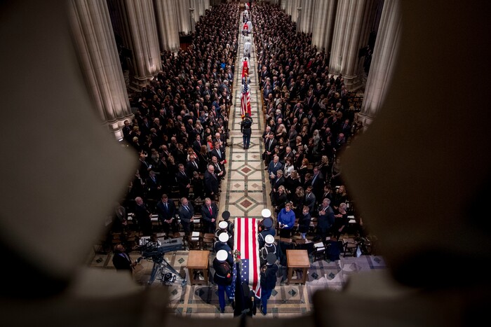 The flag-draped casket of former President George H.W. Bush is carried by a military honor guard during a State Funeral at the National Cathedral, Wednesday, Dec. 5, 2018, in Washington. (AP Photo/Andrew Harnik, Pool)