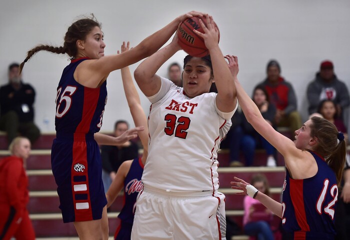 (Scott Sommerdorf   |  The Salt Lake Tribune)   Woods Cross's Riley Aiono, left, blocks Lani Taliauli's shot during first half play. East beat Woods Cross 50-36, Friday, December 15, 2017.  
