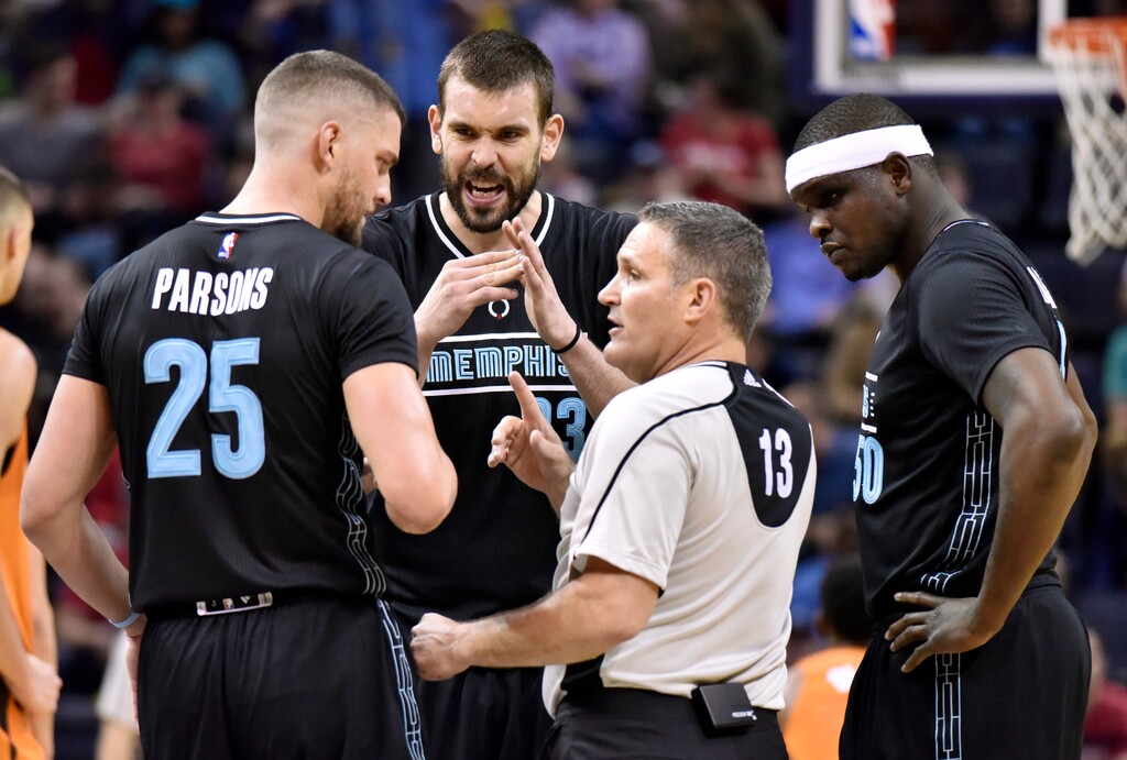 FILE - In this Feb. 28, 2017, file photo, Memphis Grizzlies forward Chandler Parsons (25), center Marc Gasol (33) and forward Zach Randolph (50) talk with referee Monty McCutchen during the first half of the team's NBA basketball game against the Phoenix Suns in Memphis, Tenn. McCutchen left his job on the floor during this season to become the league’s vice president and head of referee development and training. With tensions high this season with both players and coaches, he’s been conducting respect-for-the-game sessions with each team in hopes of creating a stronger working relationship. (AP Photo/Brandon Dill, File)