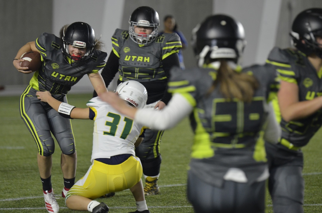 (Alex Vejar | The Salt Lake Tribune)  Murray High’s Olivia Green runs through the defense during a practice of the Utah Girls’ Tackle Football League on Wednesday, Jan. 22, 2020, at the Zions Bank Training Center in Herriman.