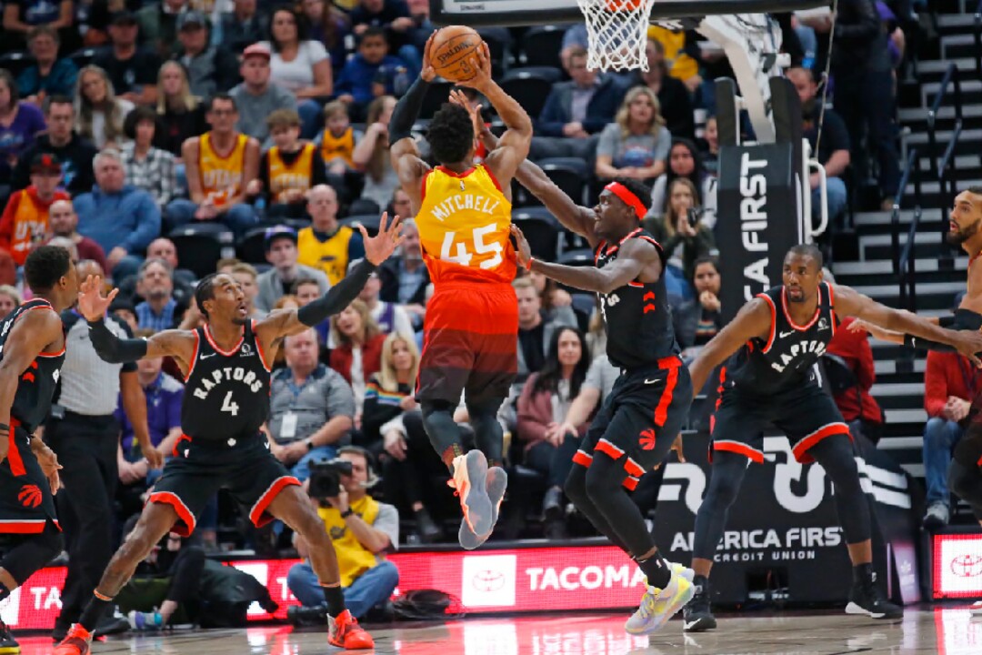 Toronto Raptors forward Rondae Hollis-Jefferson (4) defends against Utah Jazz guard Donovan Mitchell (45) who shoots in the first half during an NBA basketball game Monday, March 9, 2020, in Salt Lake City. (AP Photo/Rick Bowmer)