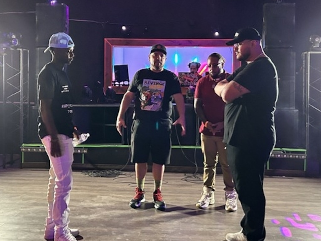 (Palak Jayswal | The Salt Lake Tribune) Rappers JayJay $avage, left, and J-Villain, right, with host and Mic Masters co-founder Gabino Chacon, center, at the "Bobby's World" rap-battle event on July 29, 2023, at The Attic in West Valley City.
