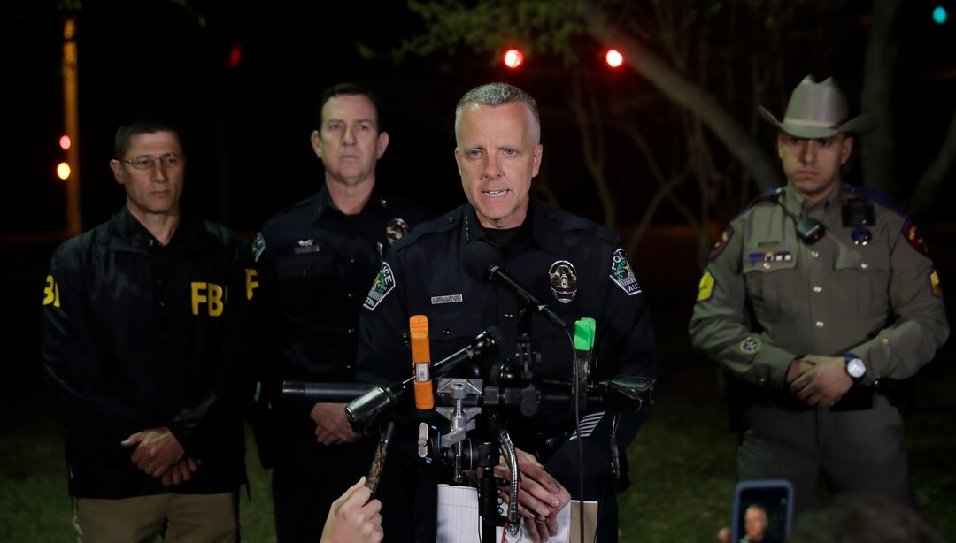 Interim Austin police Chief Brian Manley, center, talks to the media after an explosion, early Monday, March 19, 2018, in Austin, Texas. The area around the explosion site has been blocked off and authorities are interviewing neighbors and searching for possible witnesses. (AP Photo/Eric Gay)