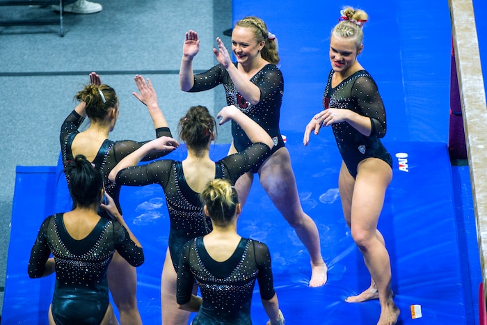 Chris Detrick  |  The Salt Lake TribuneUtah gymnast Maddy Stover celebrates with her teammates after performing on the beam during the Red Rocks Preview at the Huntsman Center Friday December 11, 2015.  