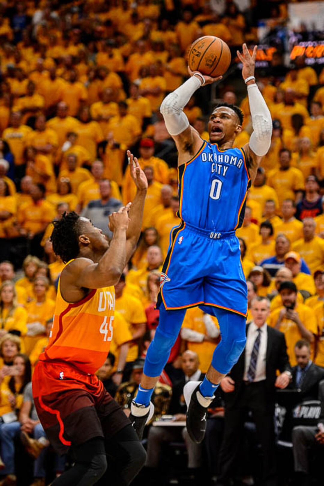 (Trent Nelson | The Salt Lake Tribune)  Utah Jazz host the Oklahoma City Thunder, Game 3, NBA playoff basketball in Salt Lake City, Saturday April 21, 2018. Oklahoma City Thunder guard Russell Westbrook (0) shoots over Utah Jazz guard Donovan Mitchell (45).