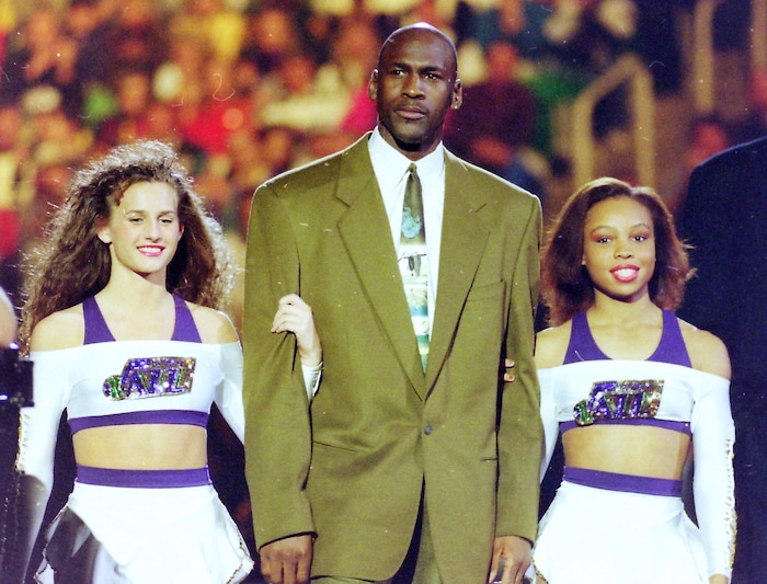 (Steve Griffin  | Tribune File Photo)  Michael Jordan is escorted onto the court by two Jazz dancers,  during the 1993 All Star festivities, in the Delta Center in Salt Lake City, Saturday, Feb. 20, 1993.