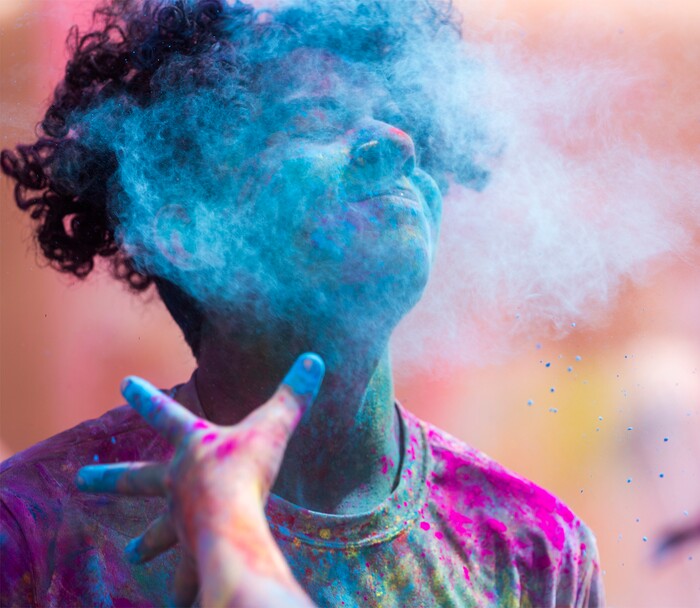 (Rick Egan | The Salt Lake Tribune) Jordan Smith gets hit with some blue colors on Saturday, March 26, 2022, at the Holi Festival of Colors in Spanish Fork. The festival included music, yoga, food, and hourly color throws for those attending.