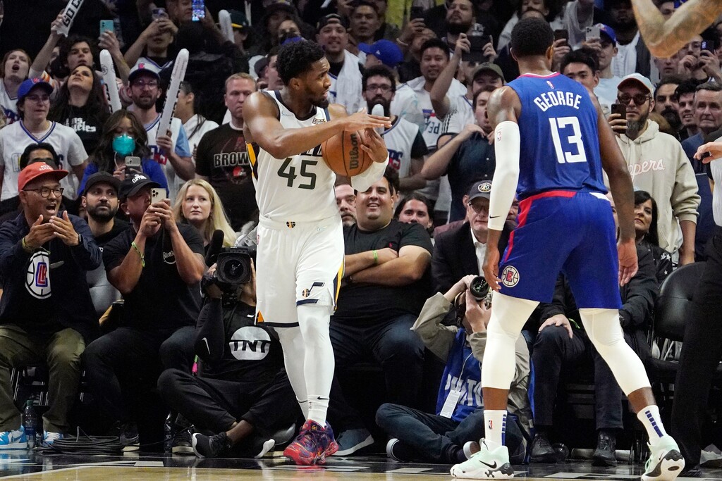 (Mark J. Terrill | AP) Utah Jazz guard Donovan Mitchell attempts to call a timeout with 10 seconds left as Los Angeles Clippers guard Paul George watches during the second half of an NBA basketball game Tuesday in Los Angeles. The Jazz were out of timeouts which resulted in a technical foul.