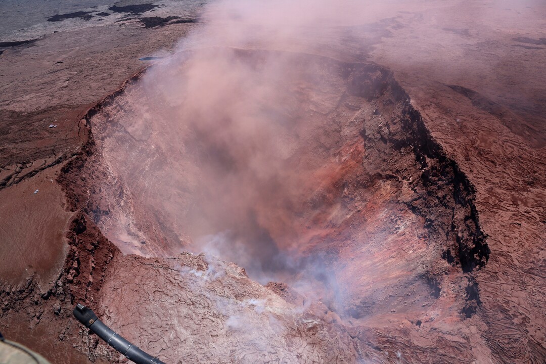 In this photo released by U.S. Geological Survey, a plume of ash rises from the Puu Oo vent on Hawaii's Kilaueaa Volcano Thursday, May 3, 2018 in Hawaii Volcanoes National Park. Hawaii's Kilauea volcano erupted Thursday, sending lava shooting into the air in a residential neighborhood and prompting mandatory evacuation orders for nearby homes. Hawaii County said steam and lava poured out of a crack in Leilani Estates, which is near the town of Pahoa on the Big Island. (U.S. Geological Survey via AP)
