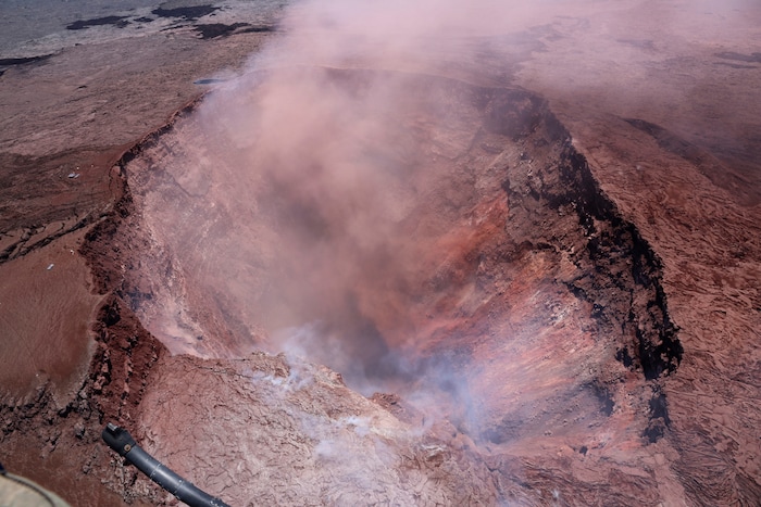 In this photo released by U.S. Geological Survey, a plume of ash rises from the Puu Oo vent on Hawaii's Kilaueaa Volcano Thursday, May 3, 2018 in Hawaii Volcanoes National Park. Hawaii's Kilauea volcano erupted Thursday, sending lava shooting into the air in a residential neighborhood and prompting mandatory evacuation orders for nearby homes. Hawaii County said steam and lava poured out of a crack in Leilani Estates, which is near the town of Pahoa on the Big Island. (U.S. Geological Survey via AP)