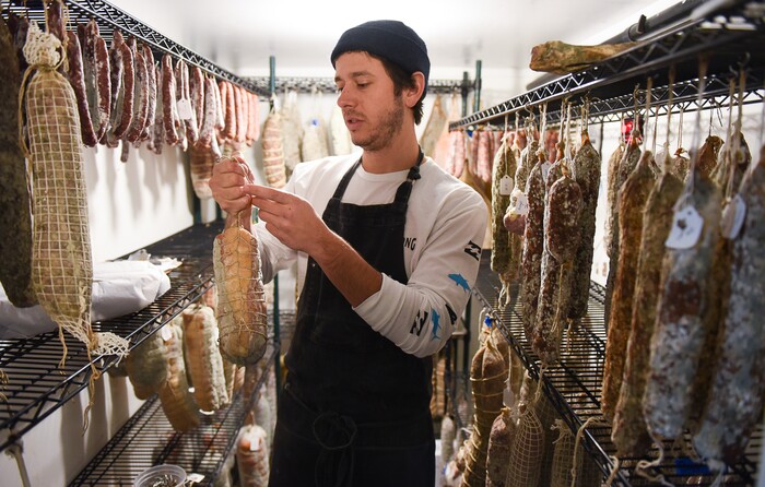 (Francisco Kjolseth  |  The Salt Lake Tribune)  Phillip Grubisa, owner of Salt Lake City's Beltex Meats, overlooks the salamis in the aging room. Beltex Meats is a finalist in the charcuterie category for its coppa, a cured pork neck and its country pate, a rustic French-style terrine made with pork liver, shoulder and cured pork jowl.