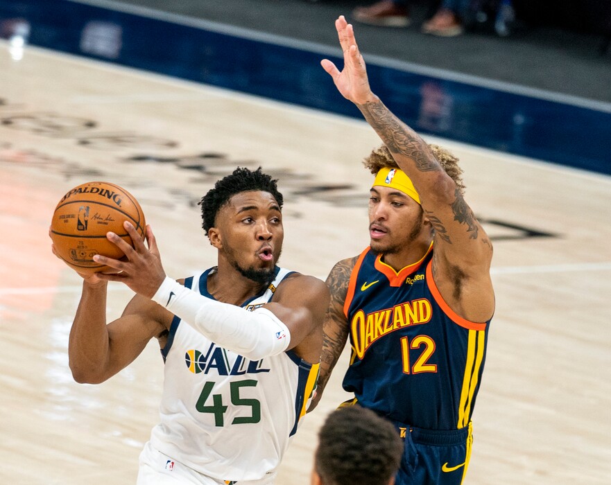 (Rick Egan | The Salt Lake Tribune) Utah Jazz guard Donovan Mitchell (45) takes the ball down court, as Golden State Warriors guard Kelly Oubre Jr. (12) defends, in NBA action between the Utah Jazz and the Golden State Warriors at Vivint Arena, on  Saturday, Jan. 23, 2021.
