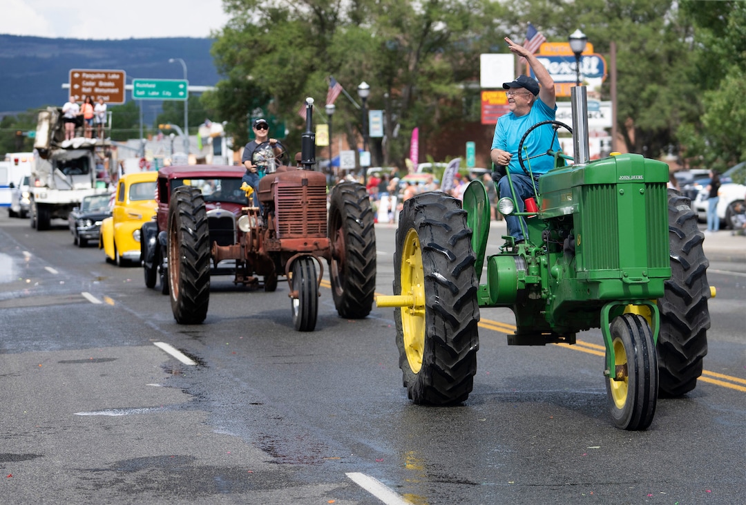 (Rick Egan | The Salt Lake Tribune) 
Tractors and antique cars roll down Center Street in Panguitch during the Pioneer Day parade in Panguitch, Saturday, July 23, 2022.
