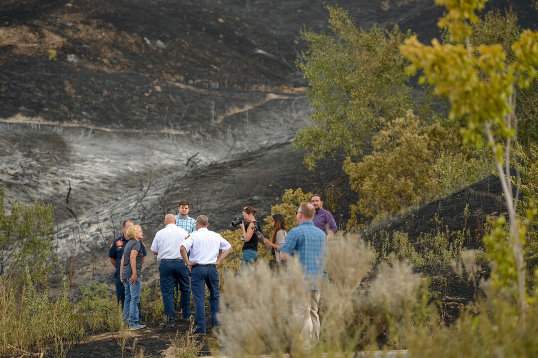 Leah Hogsten  |  The Salt Lake Tribune  l-r Salt Lake City Mayor Jackie Biskupski and Salt Lake City Fire Chief Karl Lieb tour the burned areas near Salt Lake CityÕs Ensign Peak. Five people were injured and one home was damaged by a fast-moving grass fire on Columbus Court, Tuesday, July 24, 2018. Forty homes were evacuated as flames spread through about 100 acres. Between 50 and 60 firefighters responded to the fire.