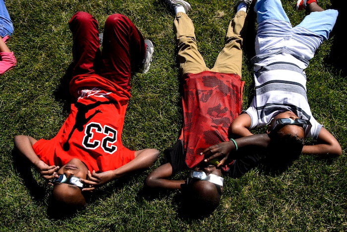(Steve Griffin  |  The Salt Lake Tribune) Meadowlark Elementary School students watch The Great Eclipse during the Salt Lake School District's first day of the 2017-2018 school year. STEAM teacher-coordinator Wendi Laurence who formerly worked at NASA has been planning an event around the eclipse. All students had glasses to view the event and many had lunch outside at the Salt Lake City school Monday August 21, 2017.
