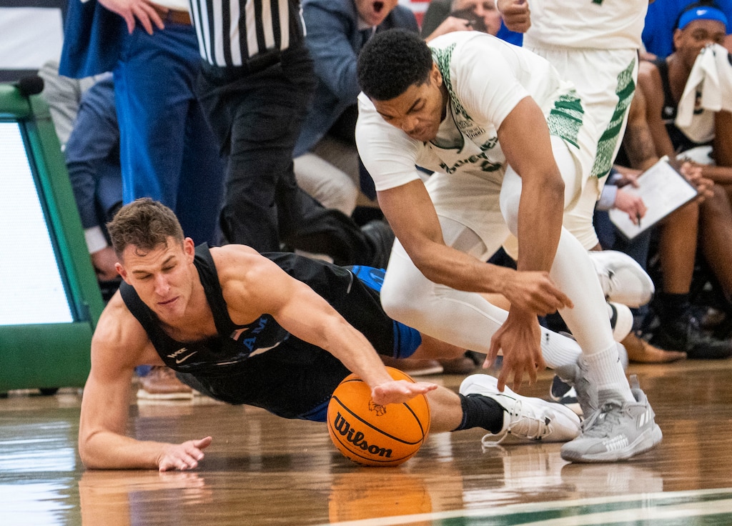 (Rick Egan | The Salt Lake Tribune) Brigham Young Cougars guard Trevin Knell (21) goes for a loose ball along with Utah Valley Wolverines forward Tim Ceaser (2), in basketball action between the Brigham Young Cougars and the Utah Valley Wolverines in Orem, on Wednesday, Dec. 1, 2021.