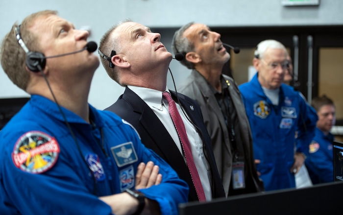 NASA astronaut Eric Boe, assistant to the chief of the astronaut office for commercial crew, left, and Norm Knight, deputy director of flight operations at NASA's Johnson Space Center watch the launch of a SpaceX Falcon 9 rocket carrying the company's Crew Dragon spacecraft on the Demo-1 mission from firing room four of the Launch Control Center, Saturday, March 2, 2019 at the Kennedy Space Center in Florida. America's newest capsule for astronauts rocketed Saturday toward the International Space Station on a high-stakes test flight by SpaceX. (NASA/Joel Kowsky)