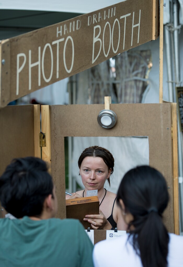 (Leah Hogsten | The Salt Lake Tribune) Artist Natalie Allsup-Edwards concentrates as she draws caricatures of festival goers at the 9th Annual Craft Lake City DIY Festival, Friday, August 11, 2017. Allsup-Edwards figures she draws caricatures for over 22 hours during the festival weekend. The festival runs through Sunday, August 13th at the Gallivan Center.
