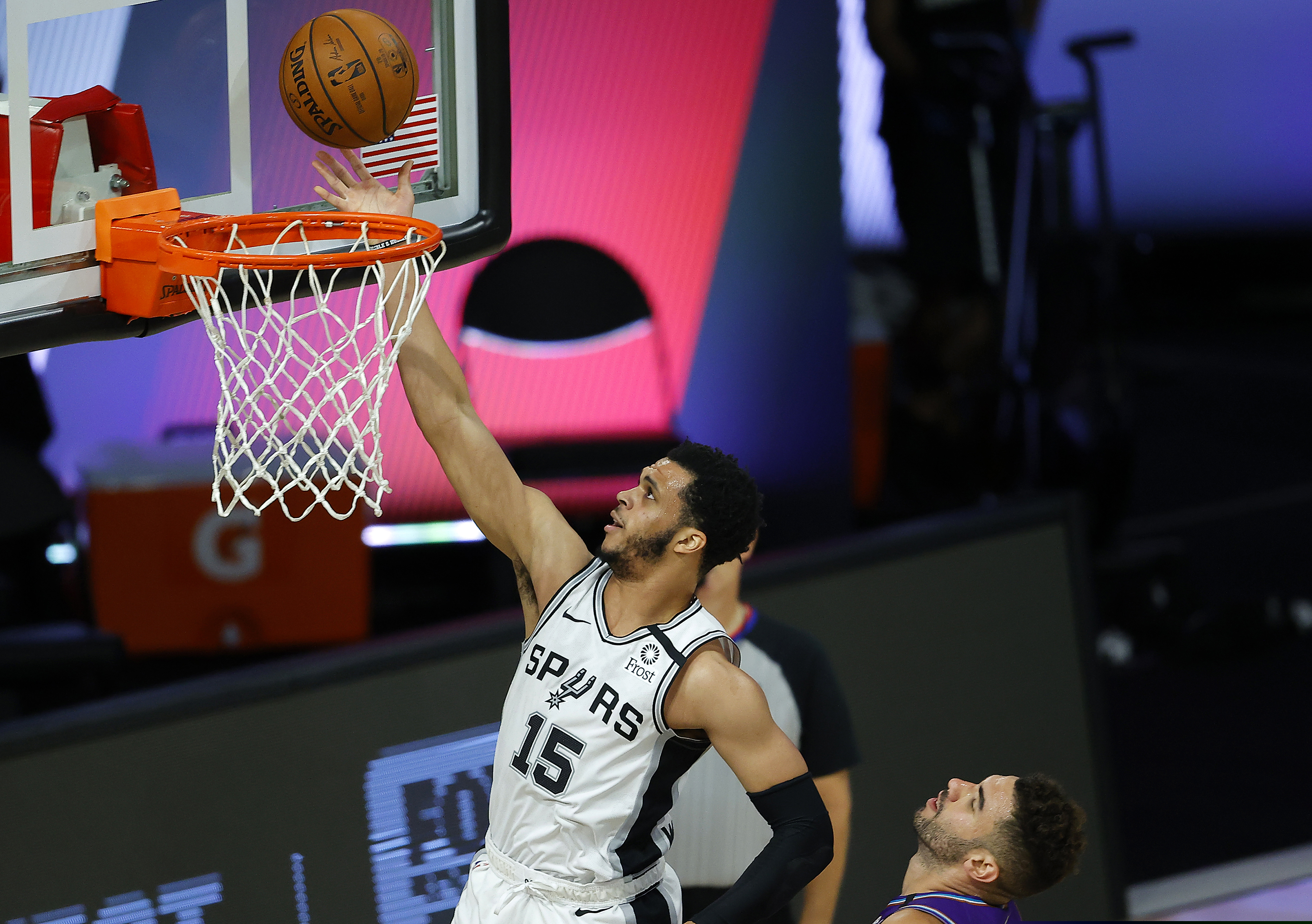 (Kevin C. Cox | Pool Photo via AP) San Antonio Spurs' Quinndary Weatherspoon (15) goes to the basket past Utah Jazz' Georges Niang during the second half of an NBA basketball game Friday, Aug. 7, 2020, in Lake Buena Vista, Fla.