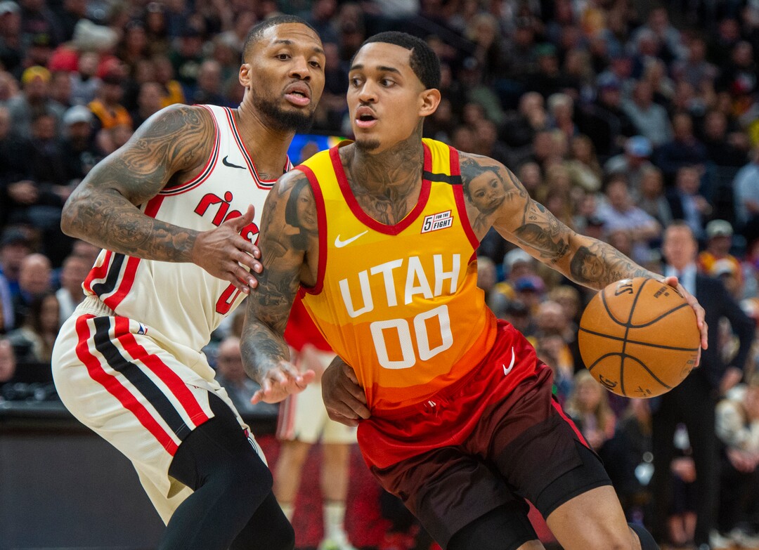 (Rick Egan  |  The Salt Lake Tribune)     Utah Jazz guard Jordan Clarkson (00) drives with the ball as Portland Trail Blazers guard Damian Lillard (0) defends, in NBA action between the Utah Jazz and thePortland Trail Blazers in Salt Lake City, Friday, Feb. 7, 2020.
