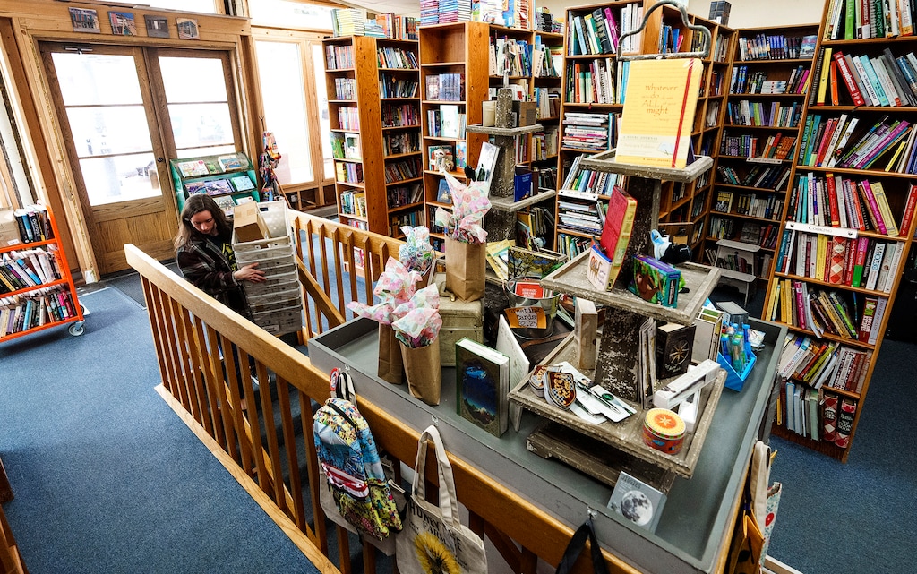 (Leah Hogsten | The Salt Lake Tribune)  Kylie Hansen, daughter of The Book Garden owners LeAnn and Ben Jorgensen walks downstairs to the trade paperback section of the bookstore, Apr. 25, 2023. 