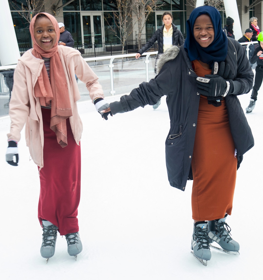 (Rick Egan  |  The Salt Lake Tribune) Halima Hassan, 12, skates with her sister Mariam Hassan, 16, at the Gallivan Center on Christmas Eve, Tuesday, Dec. 24, 2019. Tuesday was the first time on ice skates for both of the girls.