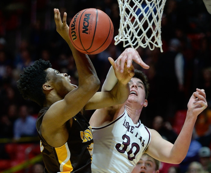 (Francisco Kjolseth  |  The Salt Lake Tribune)  Davis vs Lone Peak, 6A State high school basketball tournament at the Huntsman Center in Salt Lake City, Thursday March 1, 2018. Brendon Redford (12) battles Jasckon Brinkerhoff (30). 