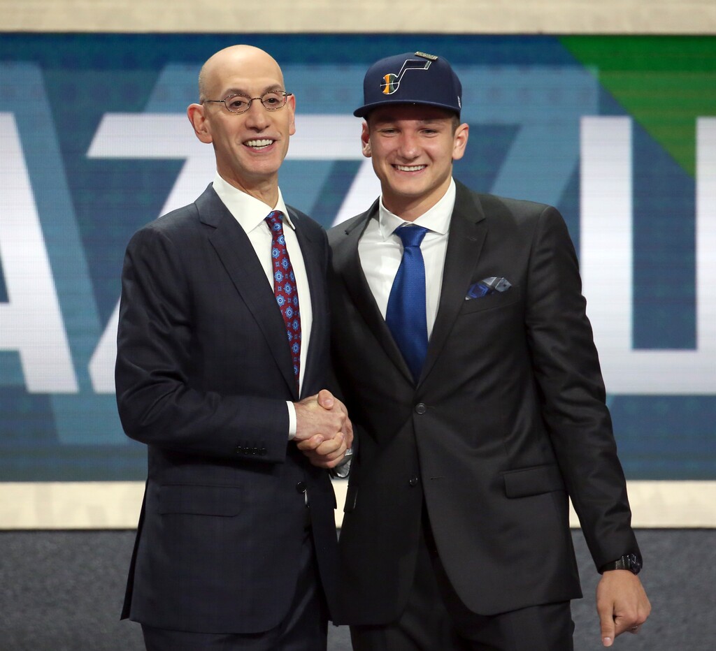 Duke's Grayson Allen, right, poses with NBA Commissioner Adam Silver after he was picked 21st overall by the Utah Jazz during the NBA basketball draft in New York, Thursday, June 21, 2018. (AP Photo/Kevin Hagen)